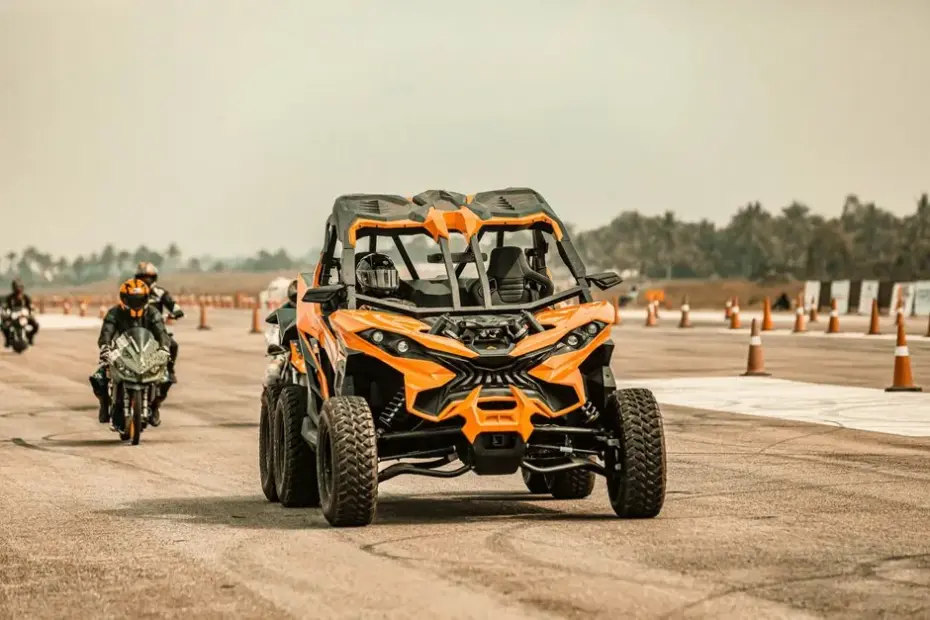 A Polaris Slingshot three-wheeled vehicle on a scenic road